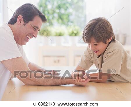 Father and son (10-11 years) arm wrestling View Large Photo Image Stock Image - Father and son (10-11 years) arm wrestling. Fotosearch