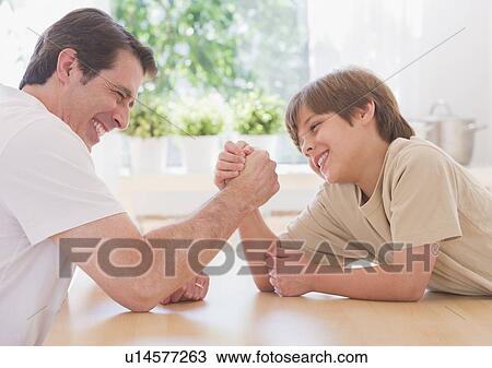 Father and son (10-11 years) arm wrestling View Large Photo Image Stock Image - Father and son (10-11 years) arm wrestling. Fotosearch