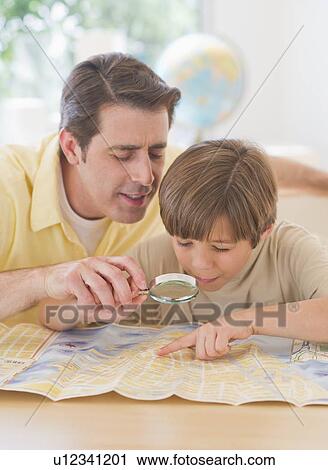 Father and son (10-11 years) reading map View Large Photo Image Stock Image - Father and son (10-11 years) reading map. Fotosearch