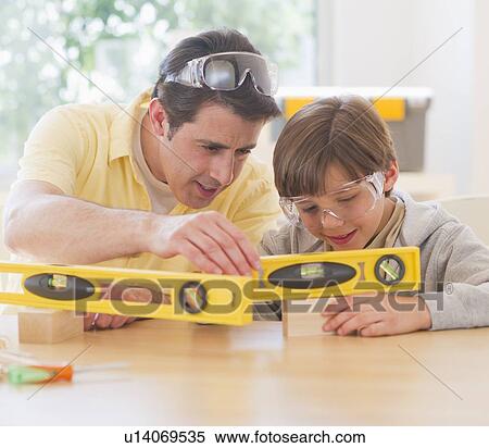 Father and son (10-11 years) using levels View Large Photo Image Stock Photography - Father and son (10-11 years) using levels. Fotosearch