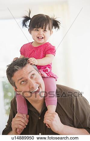 Father carrying baby daughter (12-17 months) on shoulders View Large Photo Image Stock Image - Father carrying baby daughter (12-17 months) on shoulders. Fotosearch