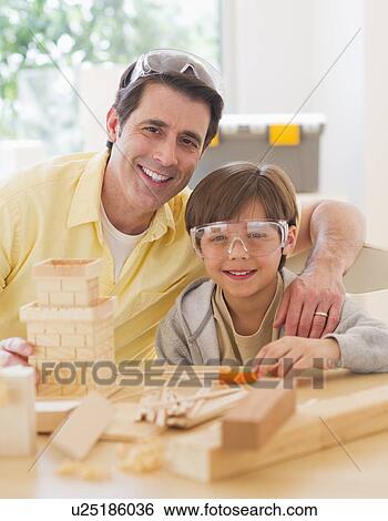 Father constructing castle with son (10-11) View Large Photo Image Stock Photograph - Father constructing castle with son (10-11). Fotosearch