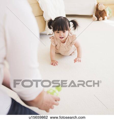 Father encouraging baby daughter (12-17 months) to crawl View Large Photo Image Stock Image - Father encouraging baby daughter (12-17 months) to crawl. Fotosearch