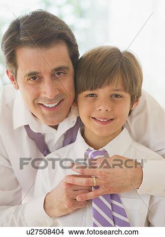 Father helping son (10-11 years) to tie tie View Large Photo Image Picture - Father helping son (10-11 years) to tie tie. Fotosearch