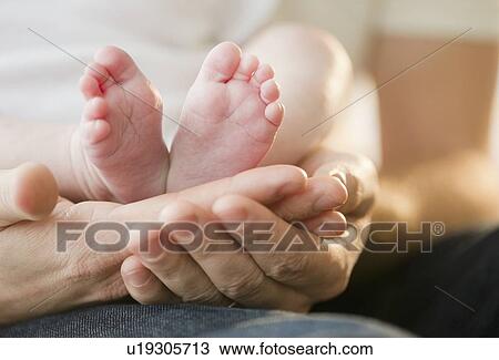 Father holding feet of baby son (2-5) View Large Photo Image Stock Image - Father holding feet of baby son (2-5). Fotosearch