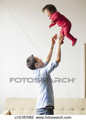 Father playing with baby girl (12-17 months) View Large Photo Image Stock Image - Father playing with baby girl (12-17 months) . Fotosearch