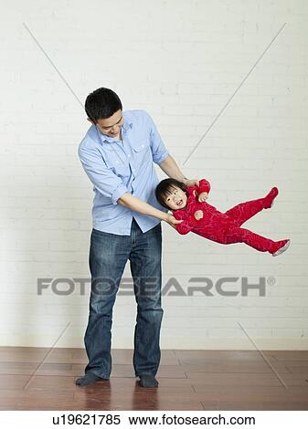 Stock Photography - Father playing with baby girl (12-17 months) . Fotosearch