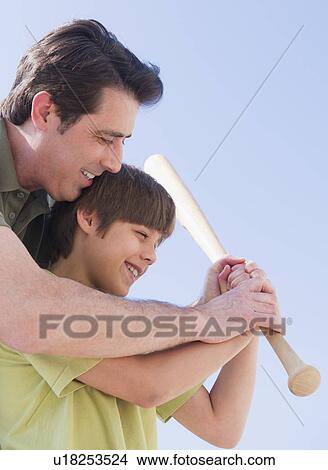 Father teaching son (10-11 years) how to play baseball View Large Photo Image Picture - Father teaching son (10-11 years) how to play baseball. Fotosearch