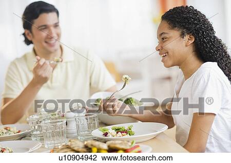 Father with daughter (10-11) eating dinner View Large Photo Image Stock Image - Father with daughter (10-11) eating dinner. Fotosearch