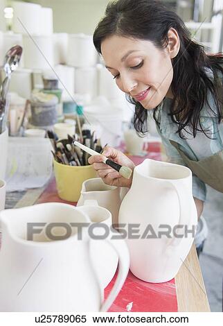 Female artist decorating pottery in studio View Large Photo Image Stock Photography - Female artist decorating pottery in studio. Fotosearch