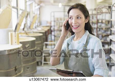 Female artist in pottery in studio View Large Photo Image Stock Image - Female artist in pottery in studio. Fotosearch