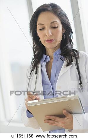 Female doctor holding medical document View Large Photo Image Stock Photo - Female doctor holding medical document. Fotosearch