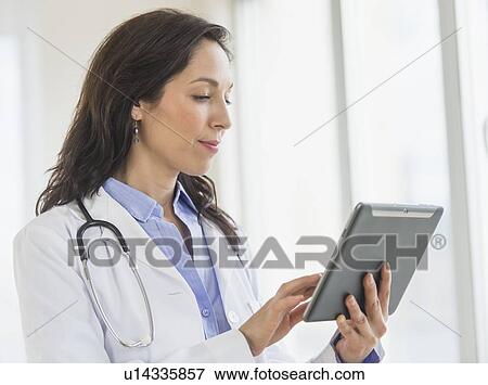 Female doctor using digital tablet View Large Photo Image Stock Photo - Female doctor using digital tablet. Fotosearch