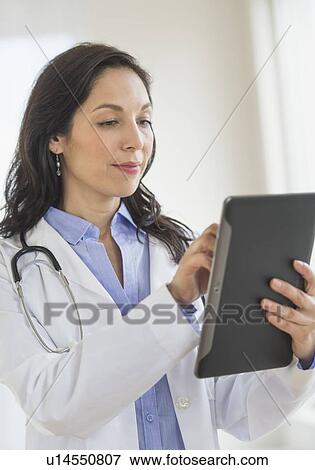 Female doctor using digital tablet View Large Photo Image Stock Photo - Female doctor using digital tablet. Fotosearch