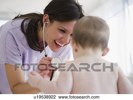 Female nurse with baby girl (6-11 months) View Large Photo Image Stock Image - Female nurse with baby girl (6-11 months). Fotosearch