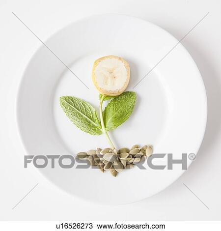 Stock Image - Flower on plate made out of food, studio shot. Fotosearch