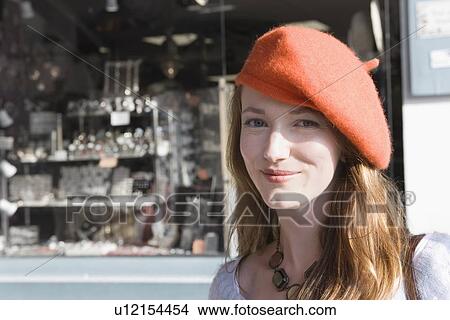 Picture - France, Pas-de-Calais, Escalles, Portrait of young woman in red beret. Fotosearch