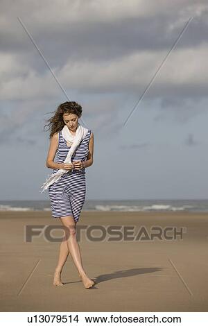 France, Pas-de-Calais, Escalles, Young woman strolling on empty beach View Large Photo Image Picture - France, Pas-de-Calais, Escalles, Young woman strolling on empty beach. Fotosearch