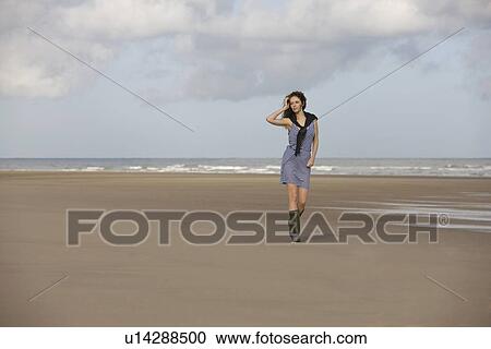 France, Pas-de-Calais, Escalles, Young woman strolling on empty beach View Large Photo Image Stock Image - France, Pas-de-Calais, Escalles, Young woman strolling on empty beach. Fotosearch