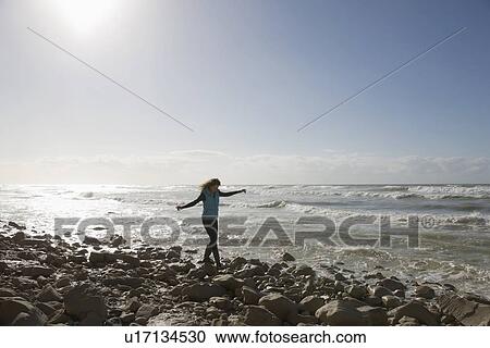France, Pas-de-Calais, Escalles, Young woman strolling on rocky beach View Large Photo Image Stock Image - France, Pas-de-Calais, Escalles, Young woman strolling on rocky beach. Fotosearch