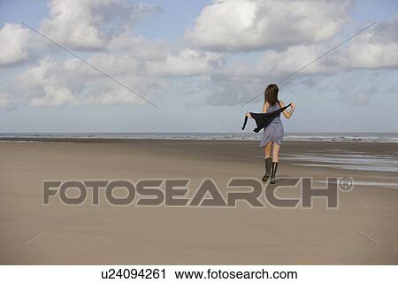 France, Pas-de-Calais, Escalles, Young woman strolling on empty beach View Large Photo Image Stock Image - France, Pas-de-Calais, Escalles, Young woman strolling on empty beach. Fotosearch