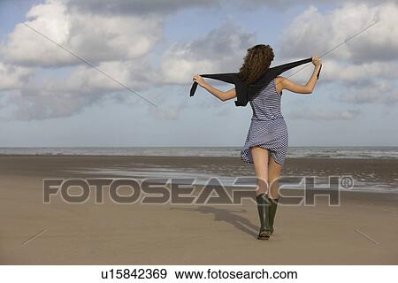 France, Pas-de-Calais, Escalles, Young woman strolling on empty beach View Large Photo Image Stock Photo - France, Pas-de-Calais, Escalles, Young woman strolling on empty beach. Fotosearch