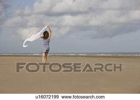France, Pas-de-Calais, Escalles, Young woman strolling on empty beach View Large Photo Image Stock Photo - France, Pas-de-Calais, Escalles, Young woman strolling on empty beach. Fotosearch