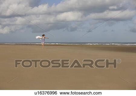 France, Pas-de-Calais, Escalles, Young woman strolling on empty beach View Large Photo Image Stock Photograph - France, Pas-de-Calais, Escalles, Young woman strolling on empty beach. Fotosearch