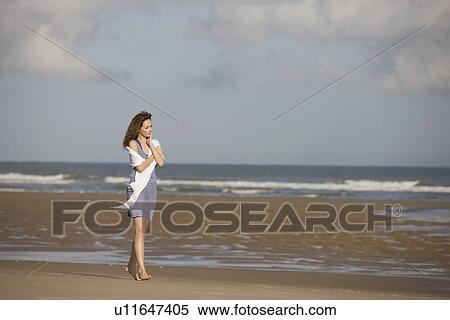 Stock Photography - France, Pas-de-Calais, Escalles, Young woman strolling on empty beach. Fotosearch