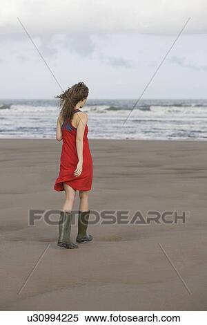 France, Pas-de-Calais, Escalles, Young woman strolling on empty beach View Large Photo Image Stock Photography - France, Pas-de-Calais, Escalles, Young woman strolling on empty beach. Fotosearch