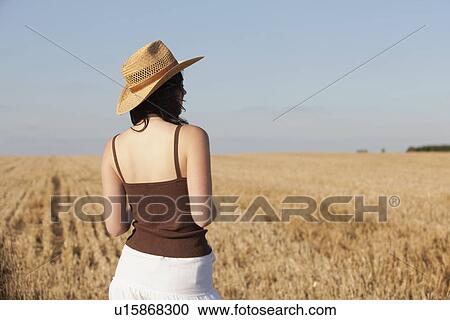 France, Picardie, Albert, Young woman in straw hat looking at country landscape View Large Photo Image Stock Image - France, Picardie, Albert, Young woman in straw hat looking at country landscape. Fotosearch
