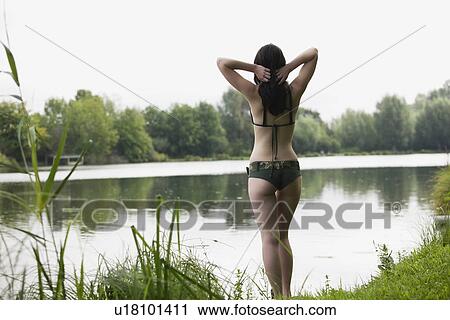 France, Picardie, Albert, Young woman in bikini standing on lake shore View Large Photo Image Stock Image - France, Picardie, Albert, Young woman in bikini standing on lake shore. Fotosearch