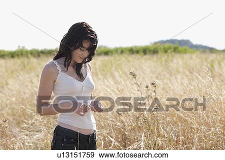 France, Picardie, Albert, Young woman standing on cornfield View Large Photo Image Stock Photo - France, Picardie, Albert, Young woman standing on cornfield. Fotosearch