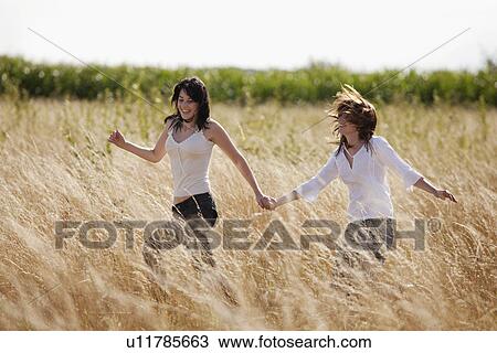 France, Picardie, Albert, Young women running through cornfield View Large Photo Image Stock Image - France, Picardie, Albert, Young women running through cornfield. Fotosearch