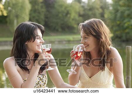 France, Picardie, Albert, Young women having picnic on lakeside View Large Photo Image Stock Image - France, Picardie, Albert, Young women having picnic on lakeside. Fotosearch