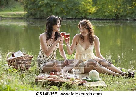 France, Picardie, Albert, Young women having picnic on lakeside View Large Photo Image Stock Photography - France, Picardie, Albert, Young women having picnic on lakeside. Fotosearch