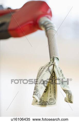 Stock Photography - Fuel nozzle with dollar bill. Fotosearch