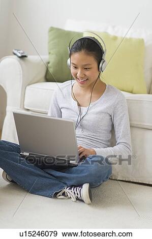 Girl (14-15) using laptop at home View Large Photo Image Stock Photo - Girl (14-15) using laptop at home. Fotosearch