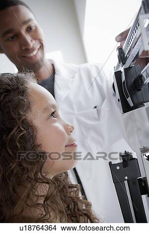 Girl (8-9) at doctor's office View Large Photo Image Picture - Girl (8-9) at doctor's office. Fotosearch
