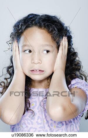 Girl (8-9) covering her ears, studio shot View Large Photo Image Stock Photograph - Girl (8-9) covering her ears, studio shot. Fotosearch