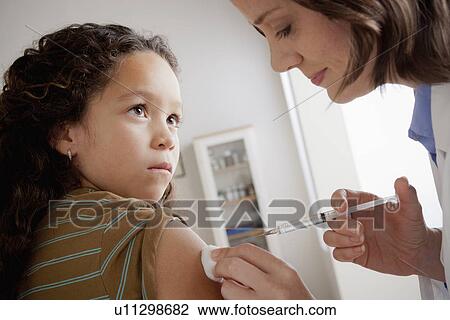 Girl (8-9) having vaccination View Large Photo Image Stock Image - Girl (8-9) having vaccination. Fotosearch