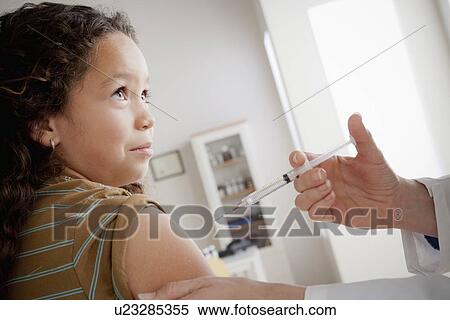 Girl (8-9) having vaccination View Large Photo Image Stock Photography - Girl (8-9) having vaccination. Fotosearch