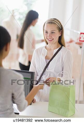 Stock Image - Girls (14-19) in shop. Fotosearch