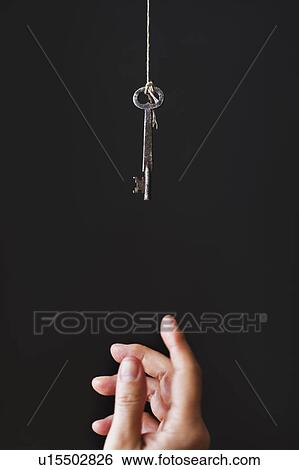 Stock Photograph - Hand reaching for key. Fotosearch