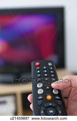 Stock Photo - Hand using remote control. Fotosearch