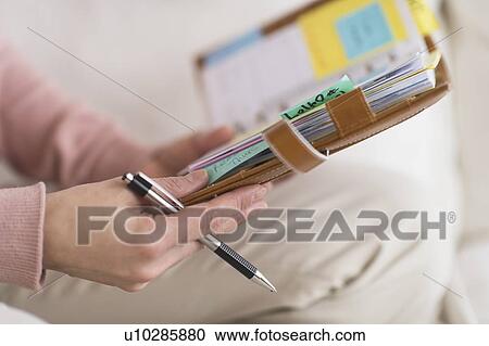 Stock Image - Hands holding personal organizer. Fotosearch