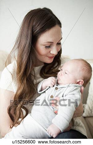 Happy young mother holding baby boy (2-5 months) View Large Photo Image Stock Image - Happy young mother holding baby boy (2-5 months). Fotosearch