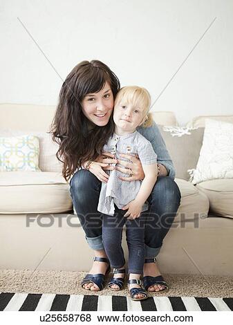 Stock Photo - Happy young mother posing with toddler girl (2-3). Fotosearch