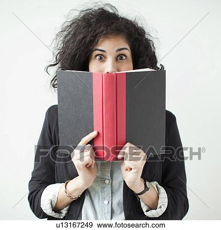 Stock Photo - Happy young woman posing with book. Fotosearch