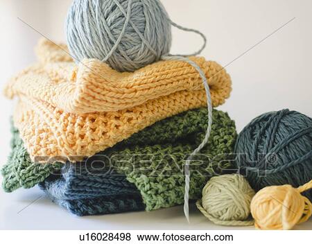 Stock Photo - Knitted blankets and balls of yarn. Fotosearch